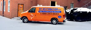 Storm Damage Restoration Van At Snowy Civic Job Site