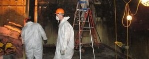 Technicians Repairing Wind and Water Damage In A Garage