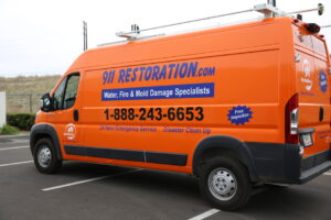 Water Damage Restoration Vans And Trucks At Job Site